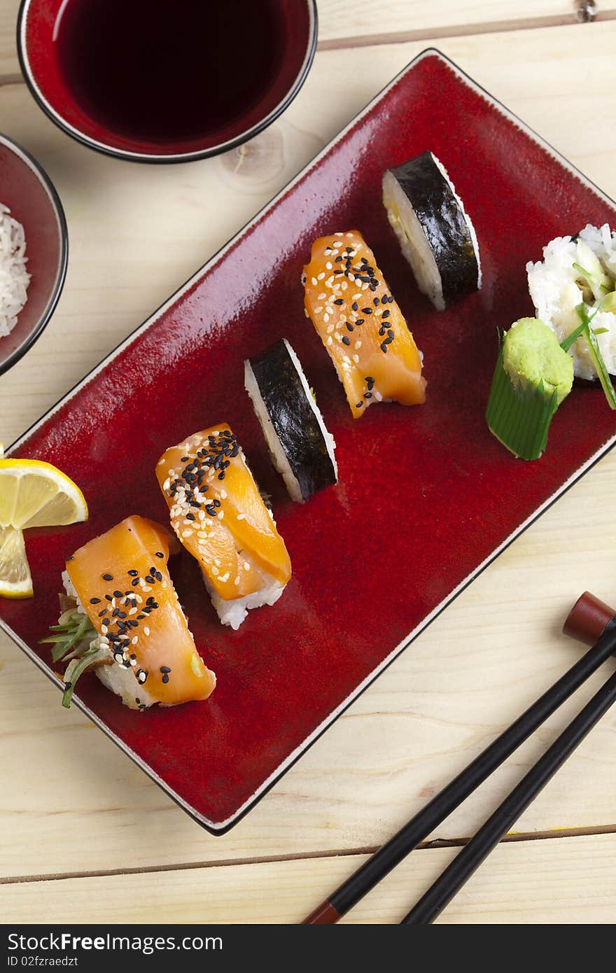 A complete sushi meal with chopsticks on tatami mat