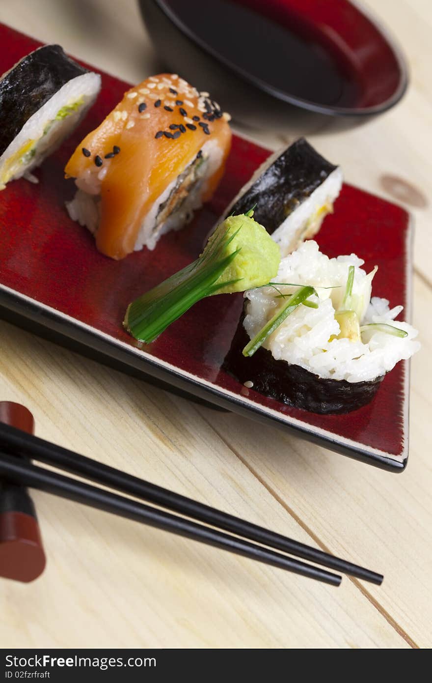 A complete sushi meal with chopsticks on tatami mat