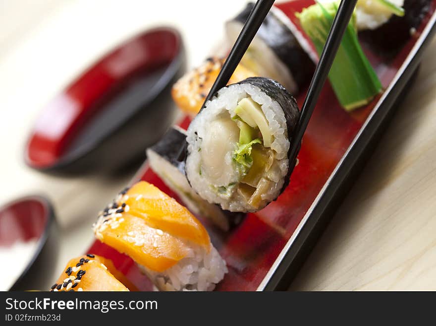 A complete sushi meal with chopsticks on tatami mat