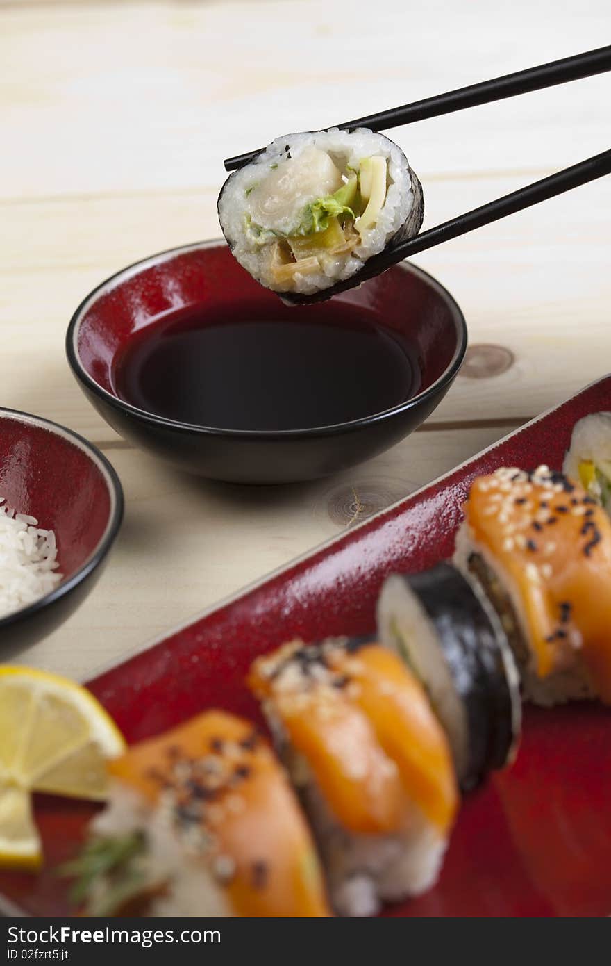 A complete sushi meal with chopsticks on tatami mat