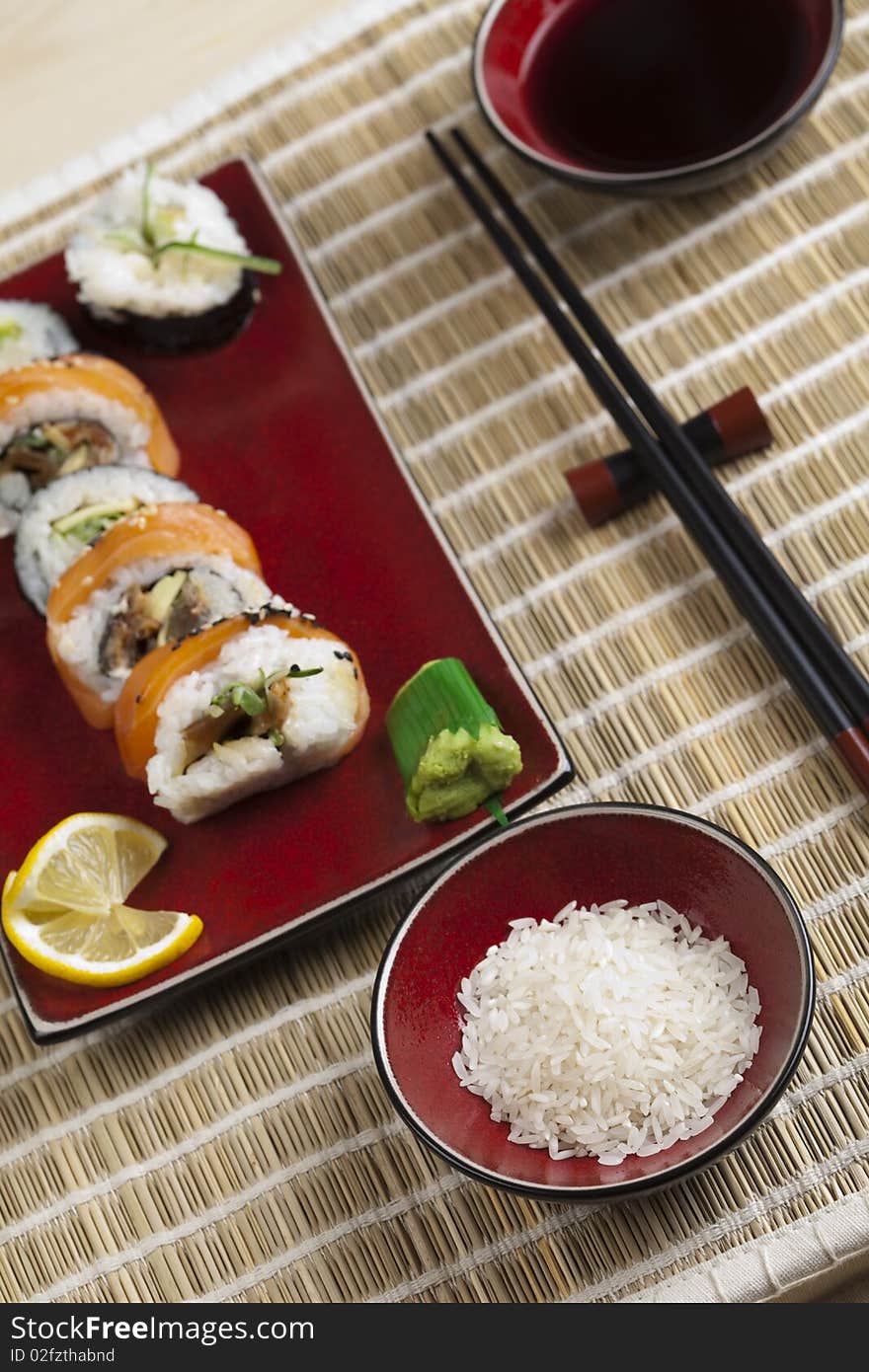 A complete sushi meal with chopsticks on tatami mat