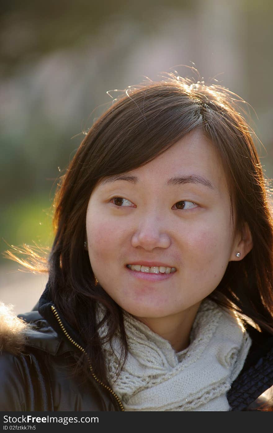 Smiling Chinese girl in Winter with white muffle.