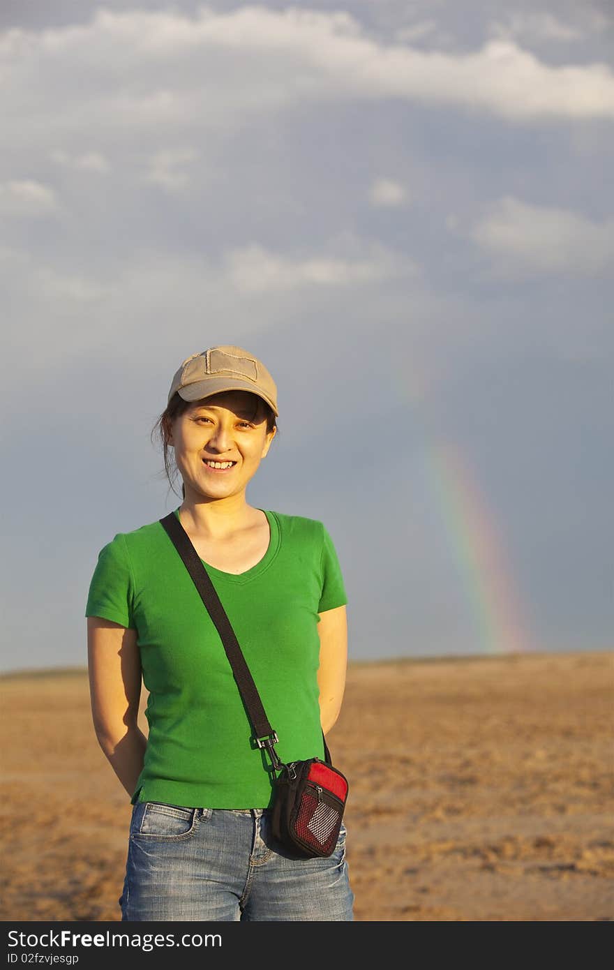 A young asian lady in the desert with rainbow. A young asian lady in the desert with rainbow