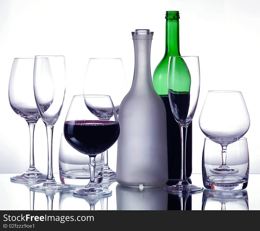 Red wine and wineglasses on a mirror table