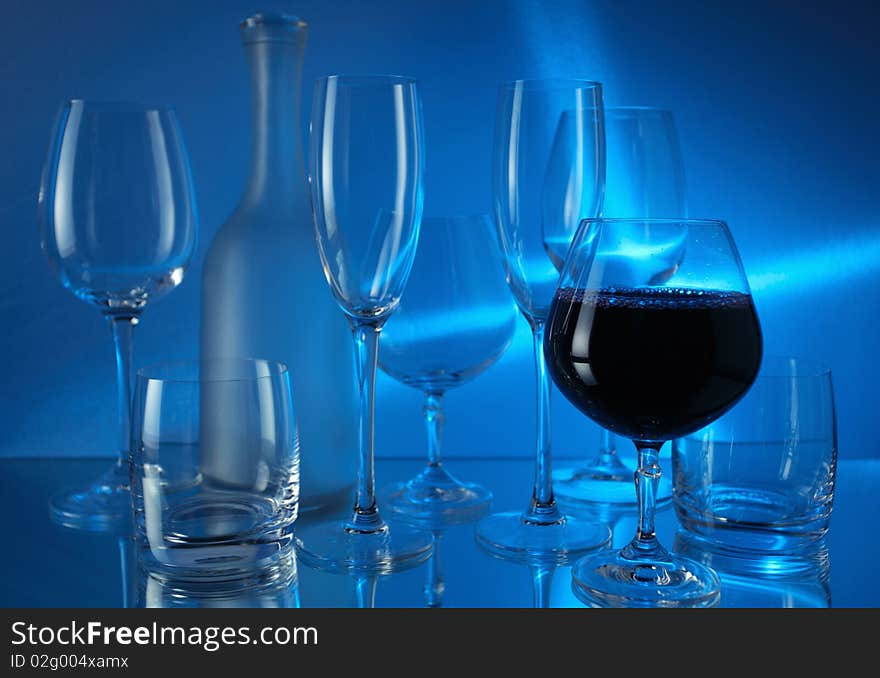 Red wine and wineglasses on a mirror table