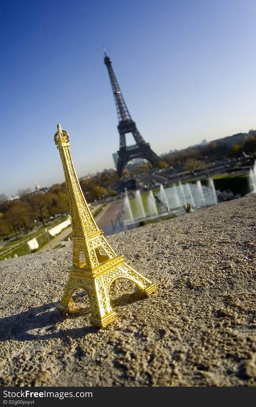 Eiffel tower miniature in front of real eiffel tower - Paris. Eiffel tower miniature in front of real eiffel tower - Paris
