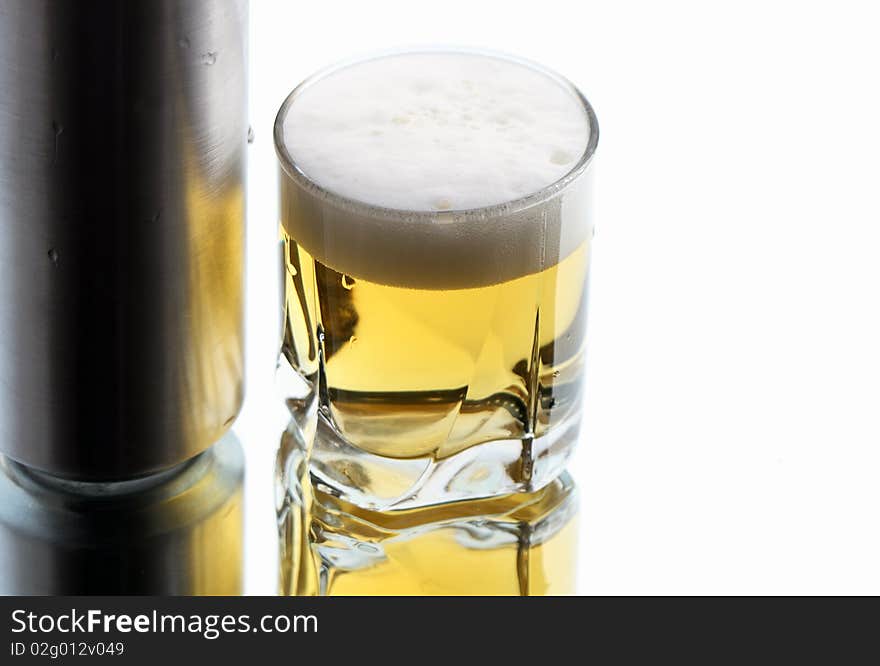 Closeup of beer glass and can on white background with reverberation. Closeup of beer glass and can on white background with reverberation