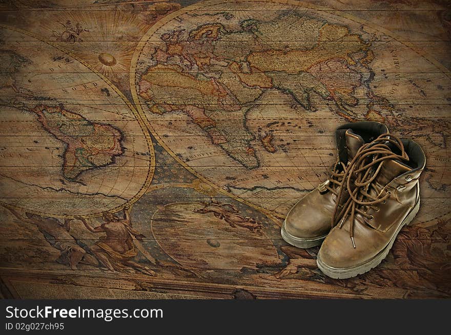 A world map on wood, with adventure boots. A world map on wood, with adventure boots