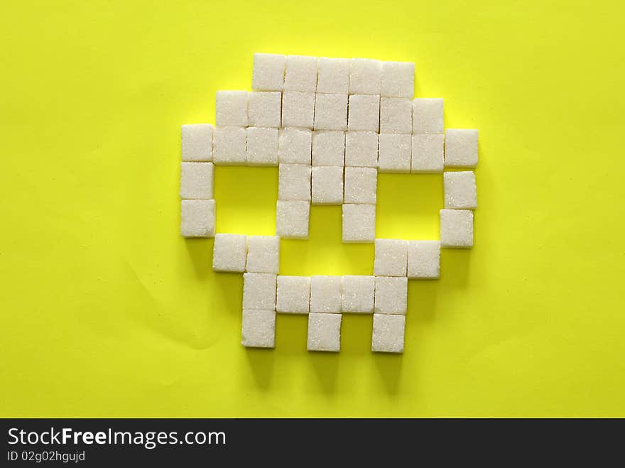 Skull from sugar slices on yellow background. Skull from sugar slices on yellow background