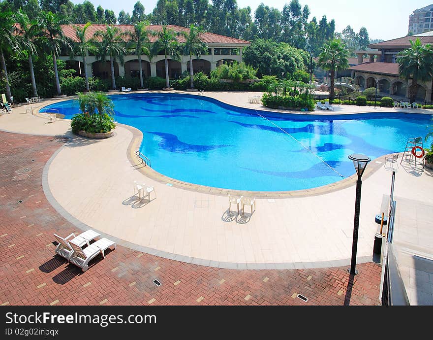 Sunny summer day large swimming pool in the hotel.