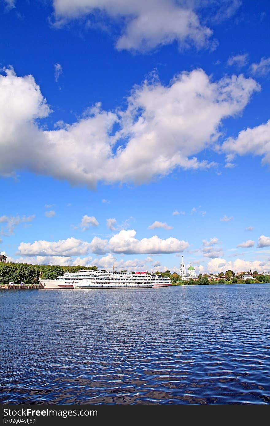 Motor ship on pier on river