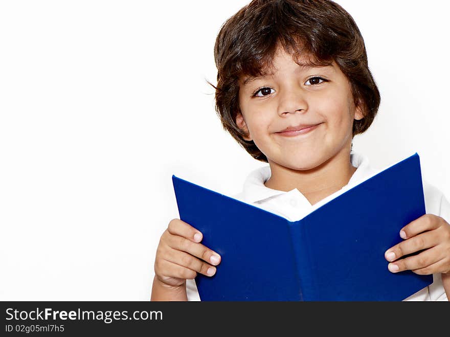 The schoolboy with the book in hands on a light background