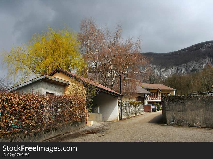 Small village street with view to the mountains Jura. Small village street with view to the mountains Jura