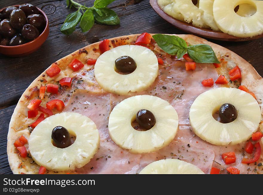 Pineapple pizza with olives and ingredients