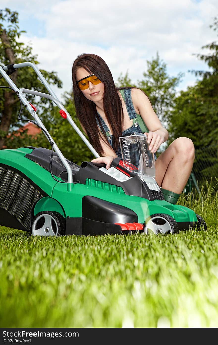 Mowing the lawn. woman working at garden