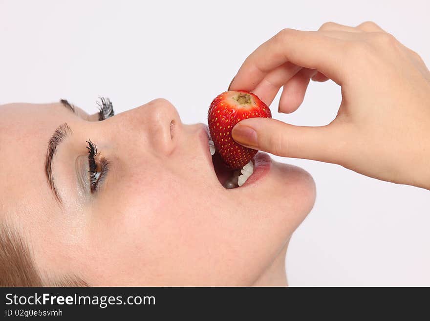 Close up of beautiful young woman eating strawberry. Close up of beautiful young woman eating strawberry