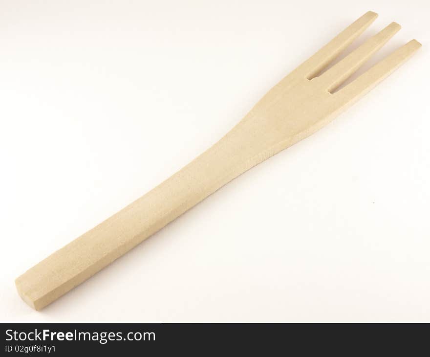 Wooden fork on the white background.