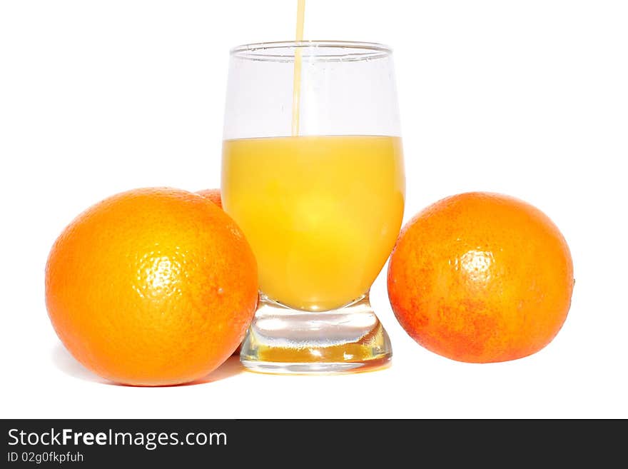 Oranges and glass of orange juice on a white background. Oranges and glass of orange juice on a white background