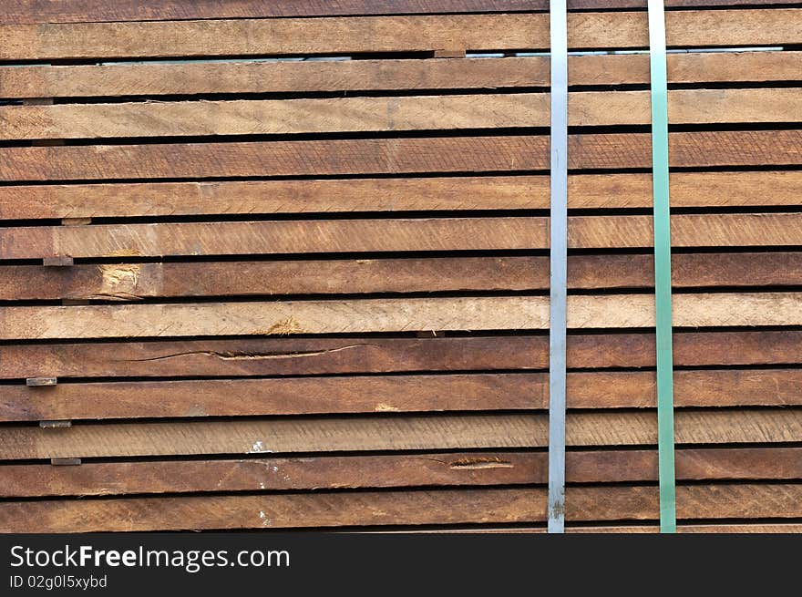 Piled up wood ready for transport at a sawmill. Piled up wood ready for transport at a sawmill