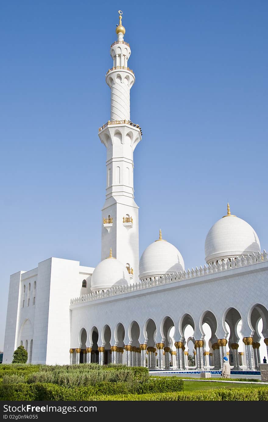 Exterior of a mosque with arches at the couryard and a minaret at the corner. Exterior of a mosque with arches at the couryard and a minaret at the corner