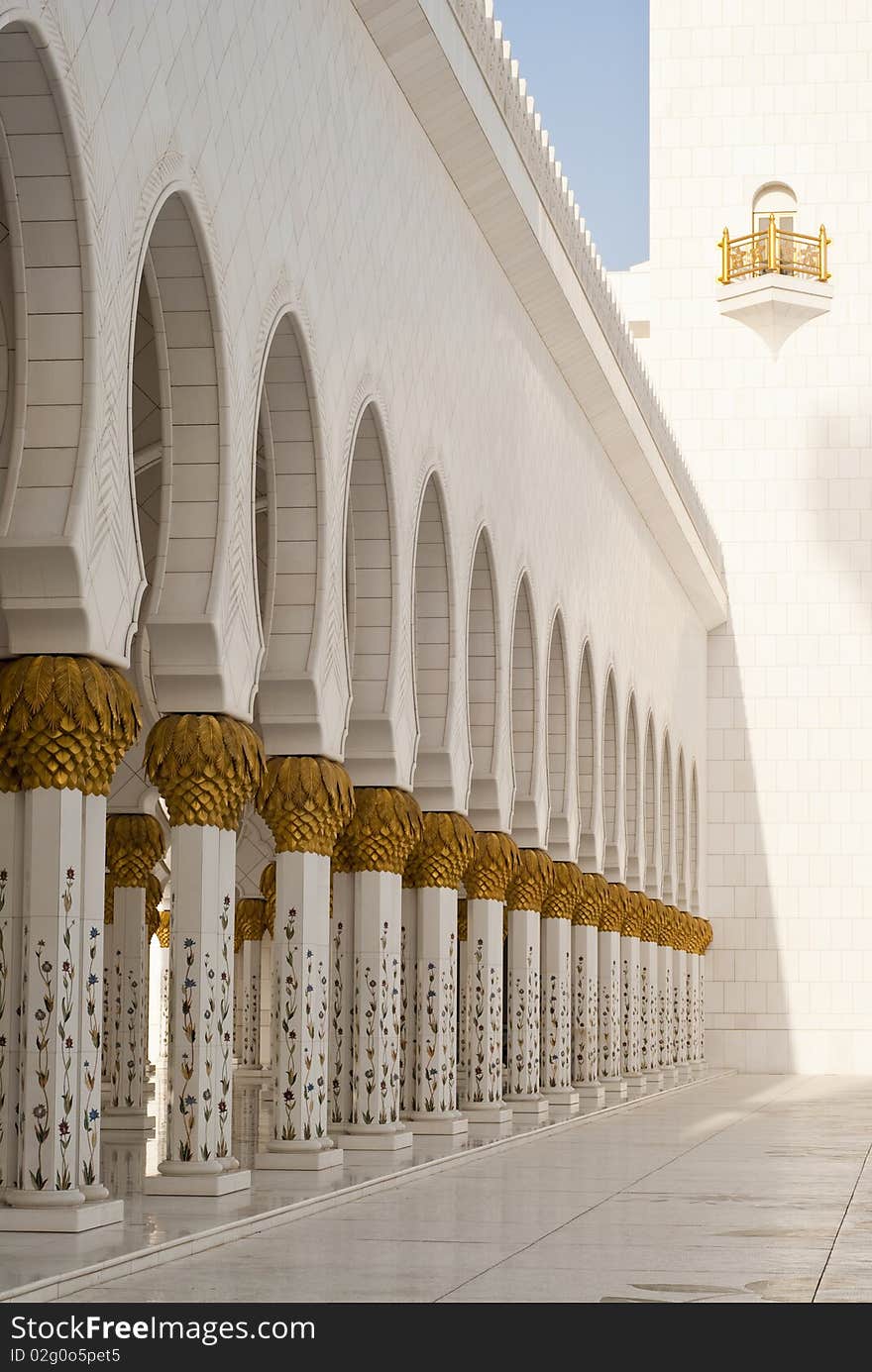 Arches at a mosque supported on fine intrecate columns with gold palm capitals