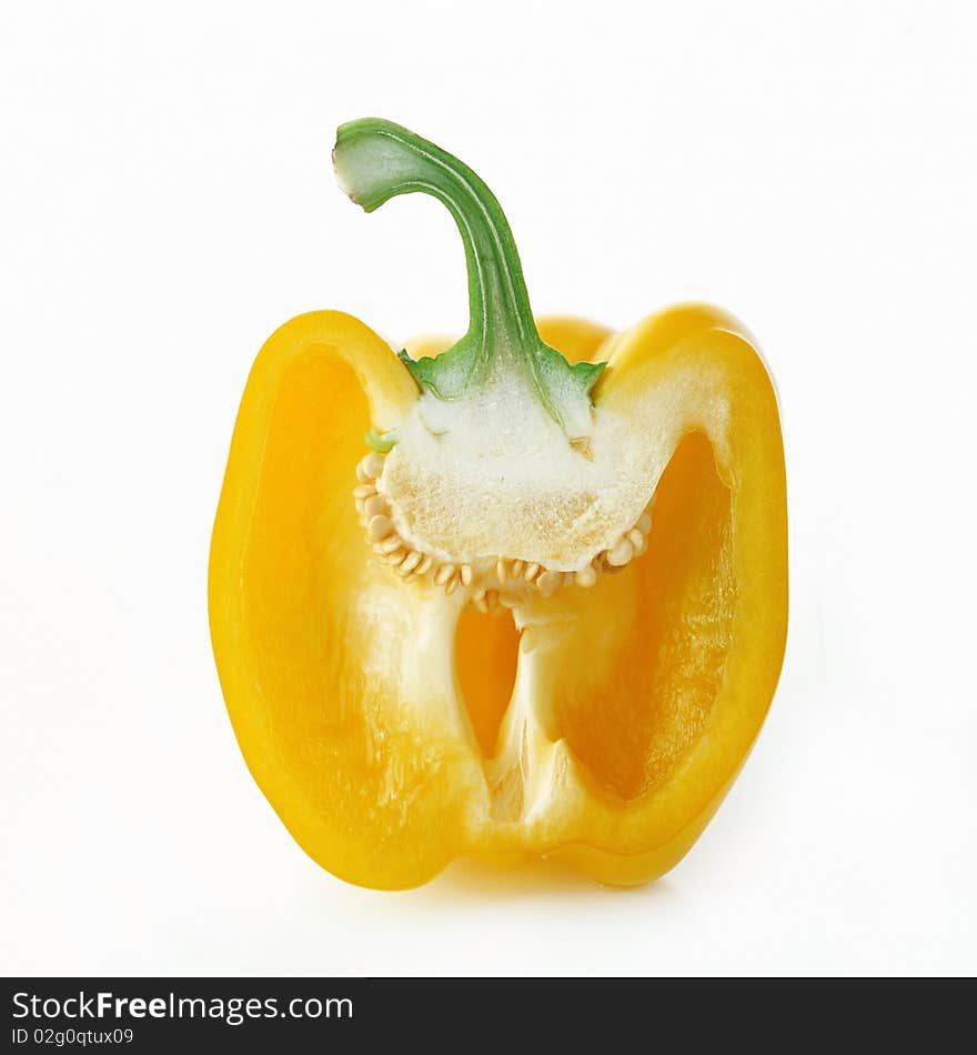 Yellow pepper cut into halves on a white background. Yellow pepper cut into halves on a white background