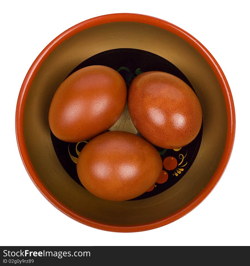 Easter eggs in Russian national bowl on a white background