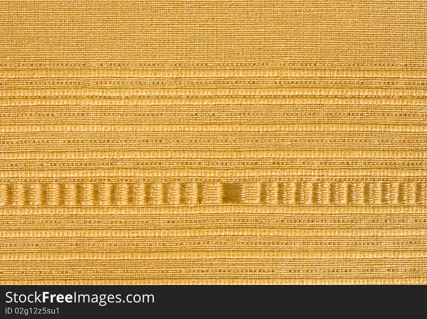 A close up of a yellow striped fabric background