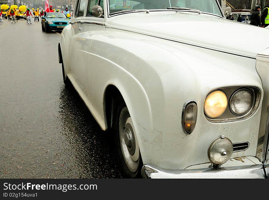 Old white car moving on the road. Old white car moving on the road