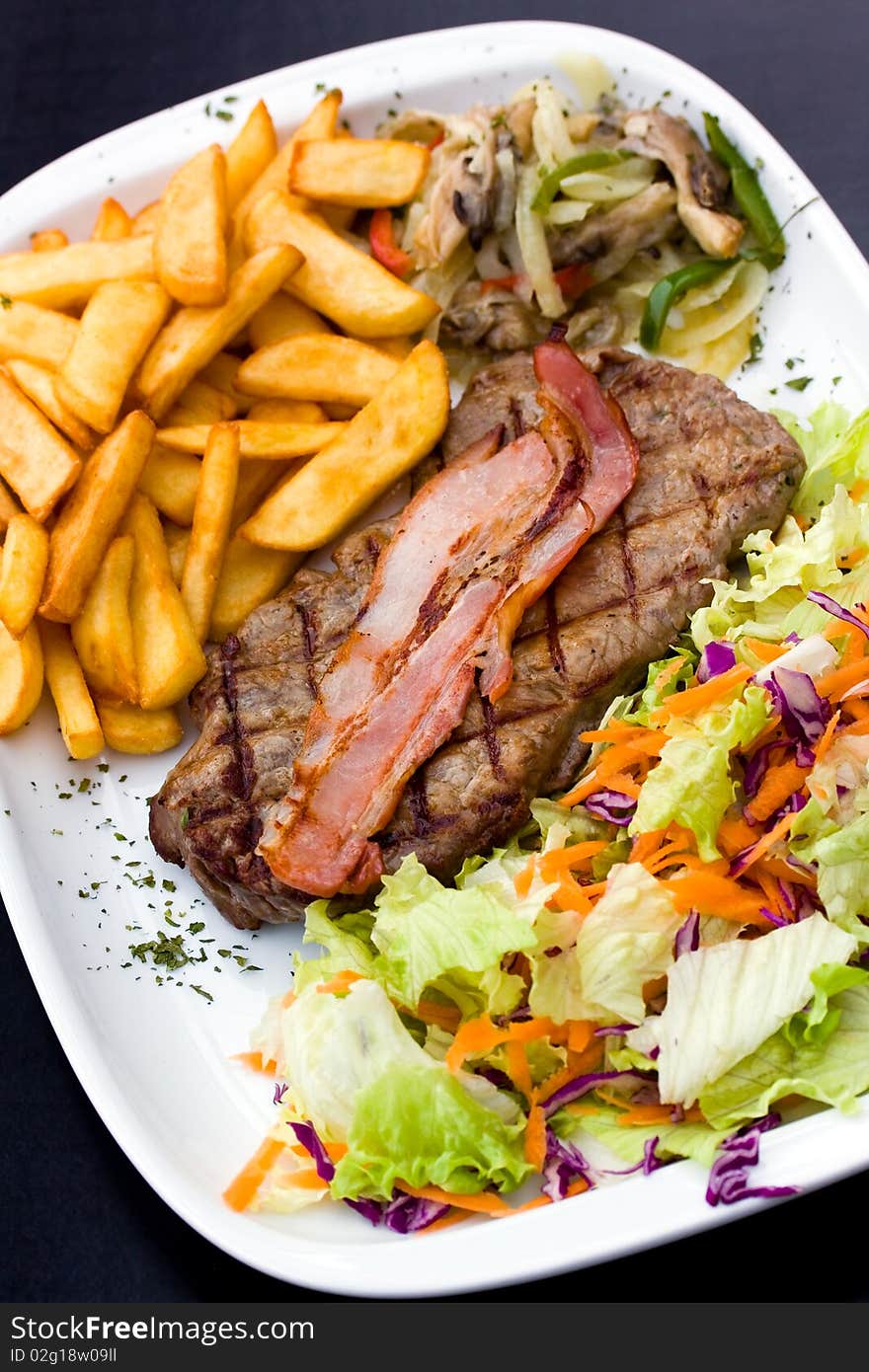 Sirloin steak with chips and bacon