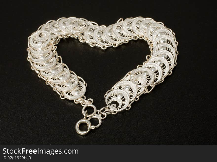 Silver necklace on a black background