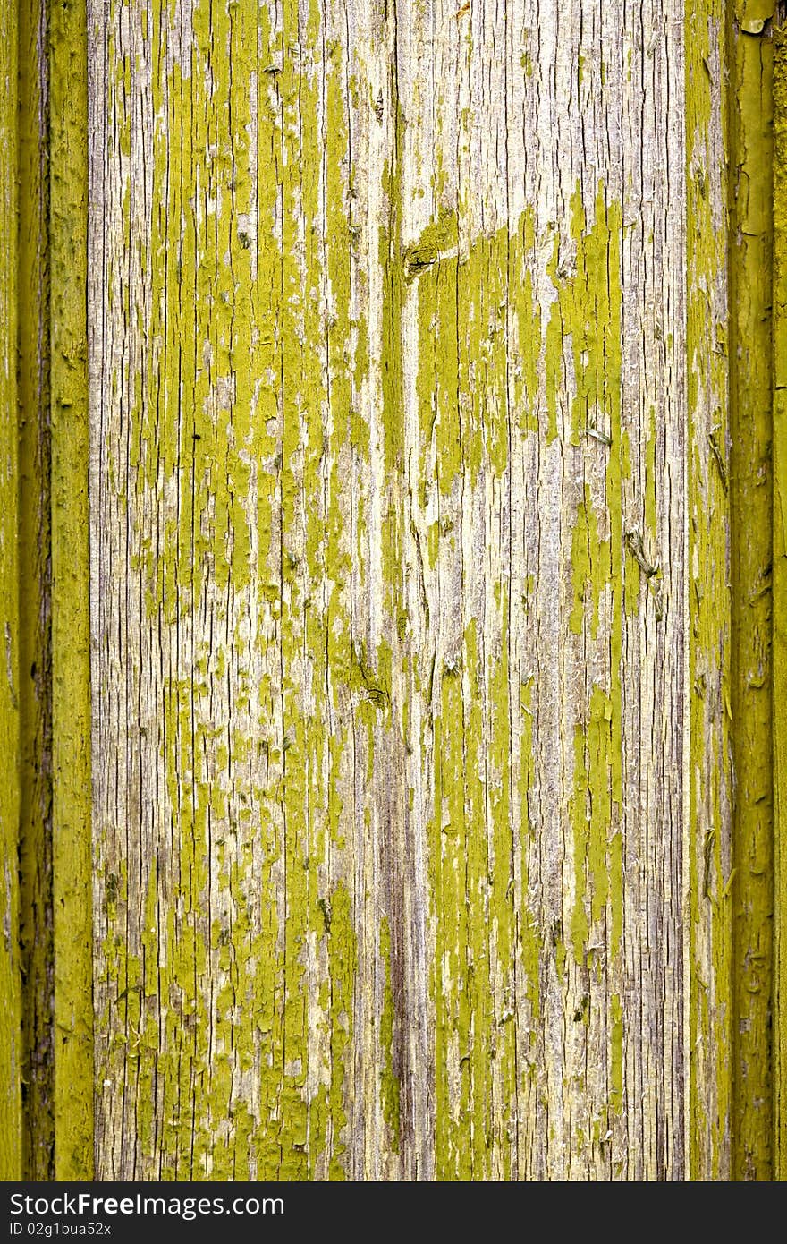 Old wooden board with flaked green paint