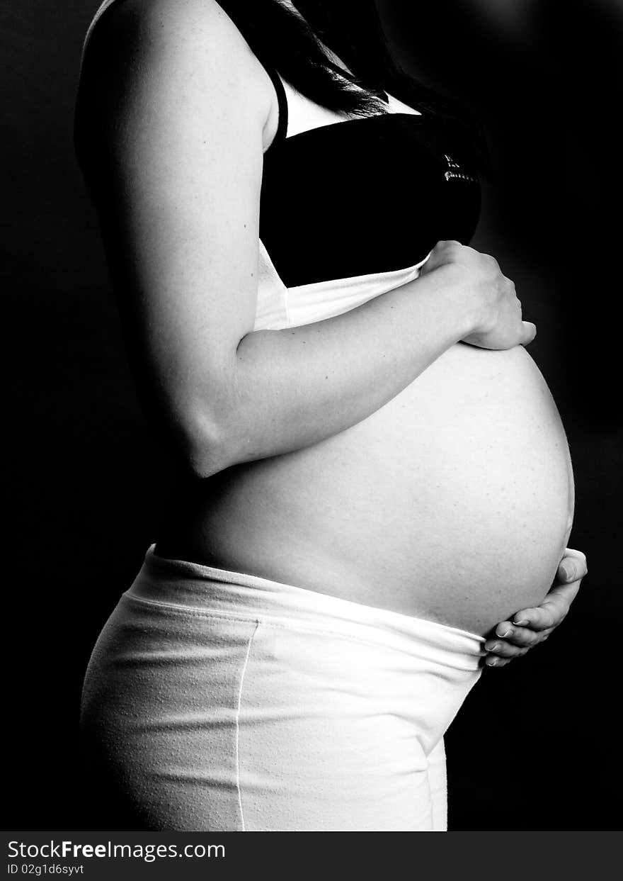 A shot of a beautiful pregnant woman in black and white