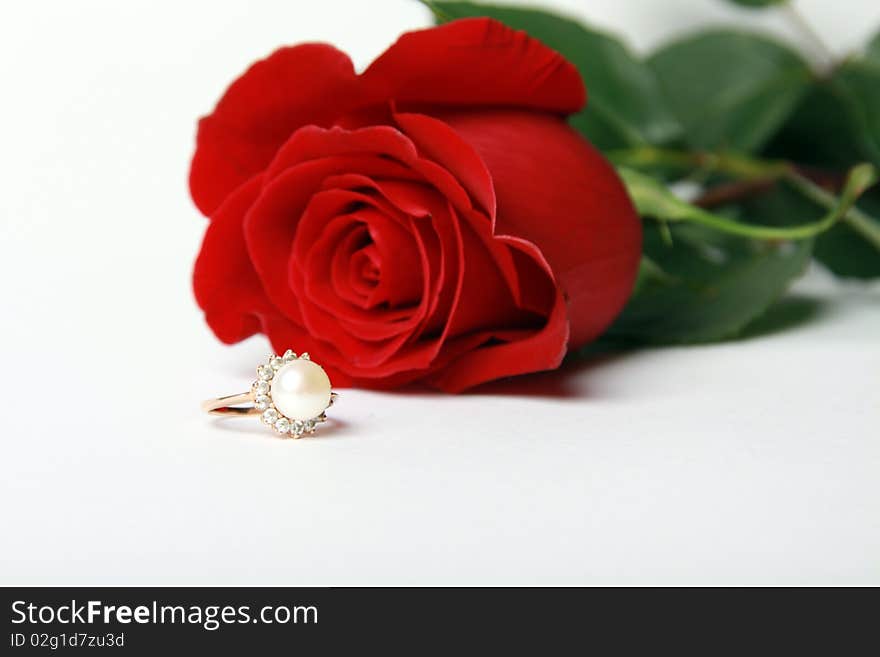 Ring with pearl and red rose on white