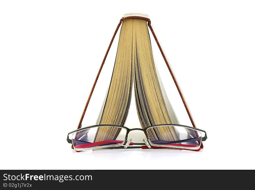 A open book and a glasses. A open book and a glasses