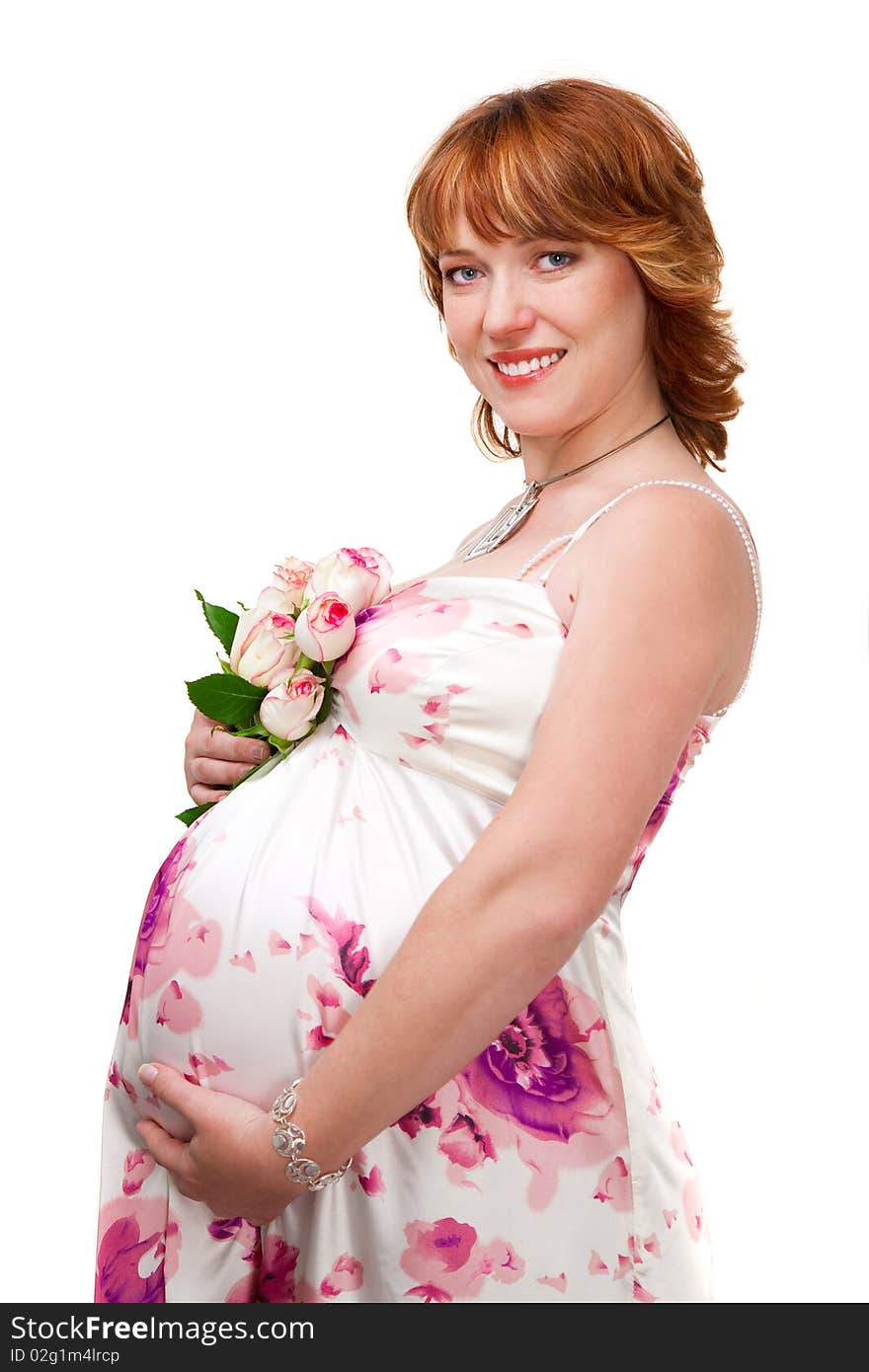 Pregnant woman wearing evening dress with bouquet of white roses