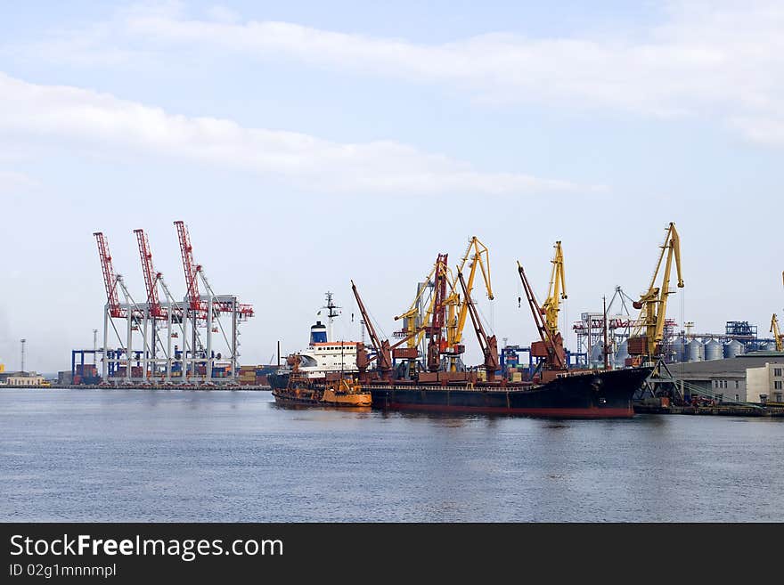 Port with cargo cranes and vessel