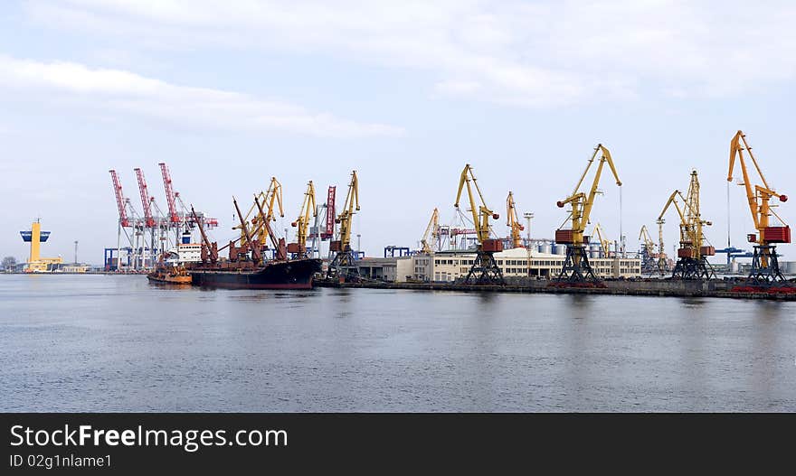 Panorama of the port with cargo cranes and vessel