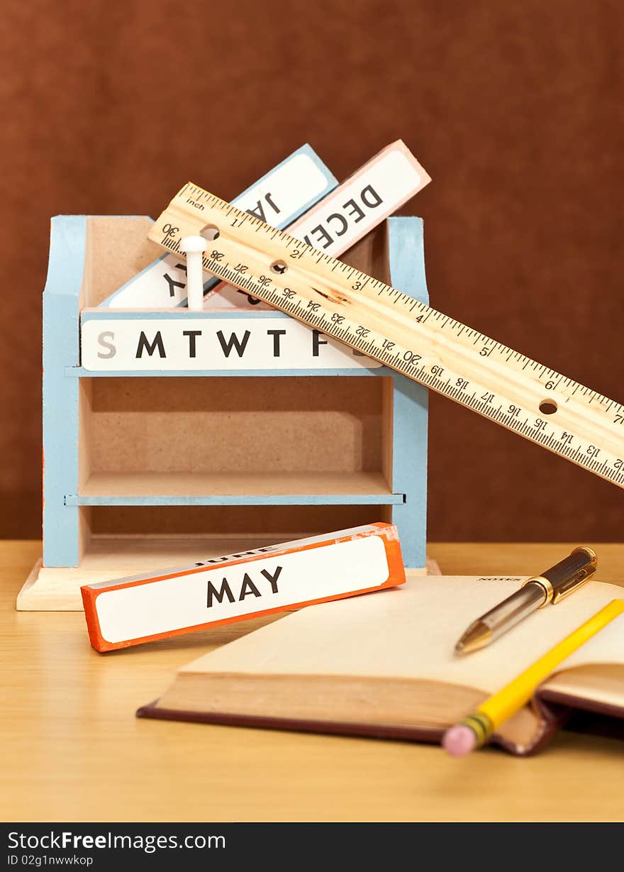 Month Blocks Desk Calendar with Books and Pen. Month Blocks Desk Calendar with Books and Pen