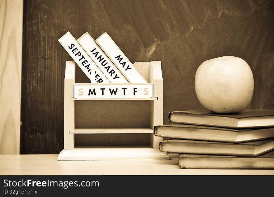 Aged Photo of Monthly Desk Calendar with Apples and Books. Aged Photo of Monthly Desk Calendar with Apples and Books