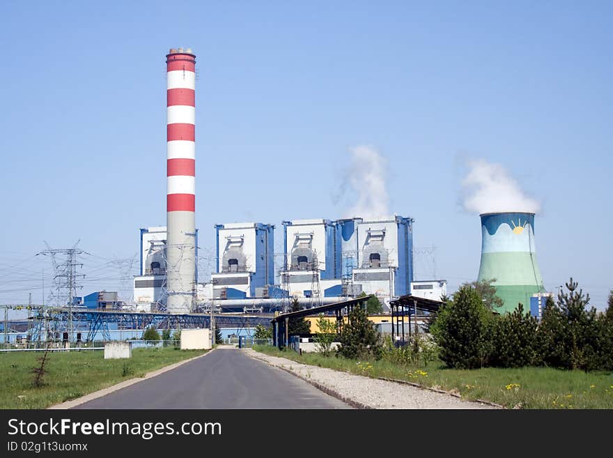 Cooling towers of power plant over blue sky with steam and co2 clouds. Cooling towers of power plant over blue sky with steam and co2 clouds