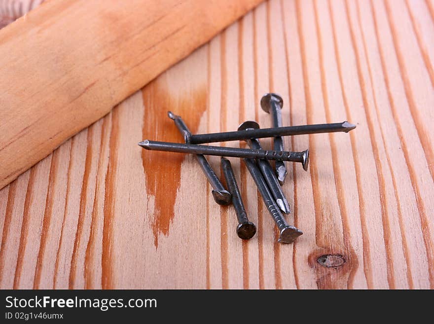 Nails for civil work against a wooden board.