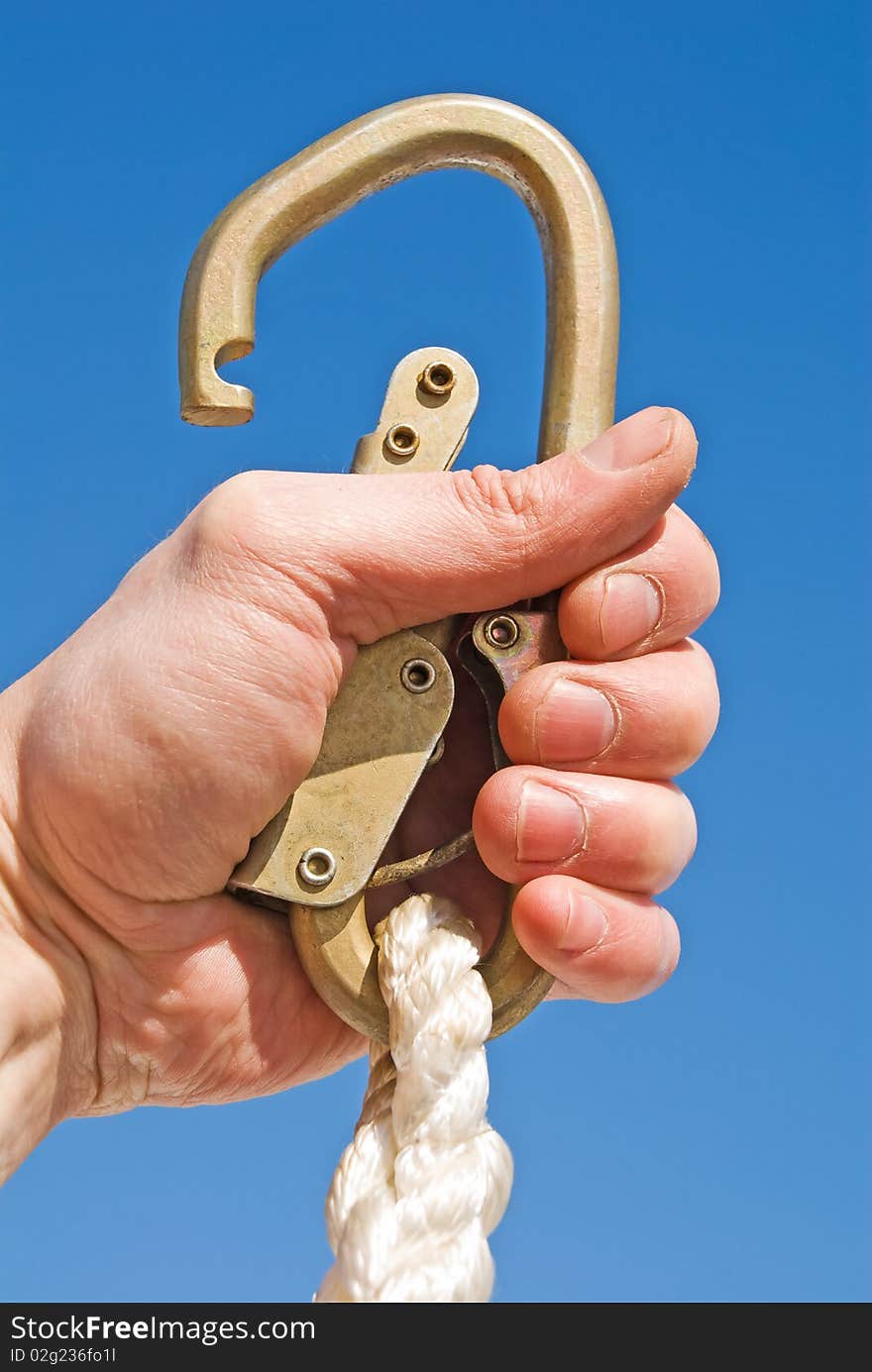 Hand with a carbine in the blue sky