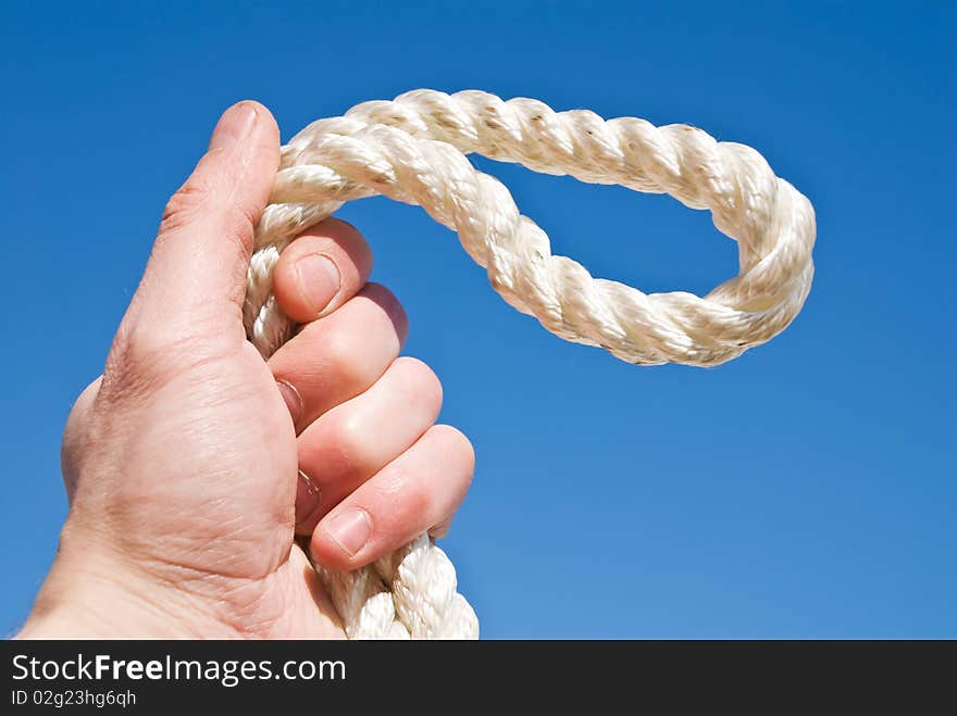 Cord in a hand on a blue background