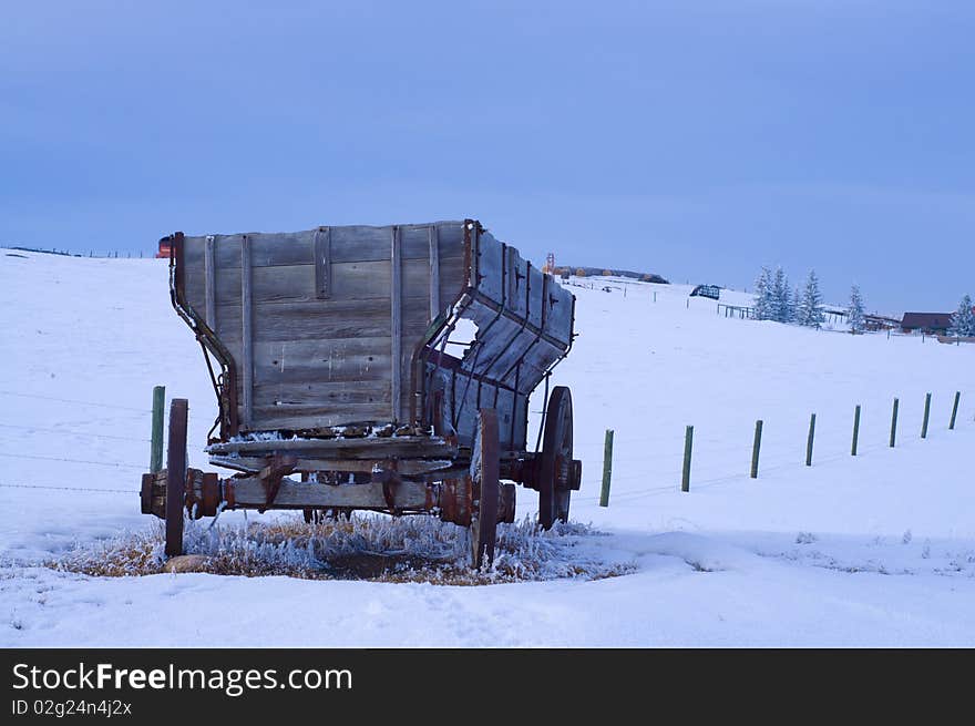 Old Antique Wagon in snow covered field