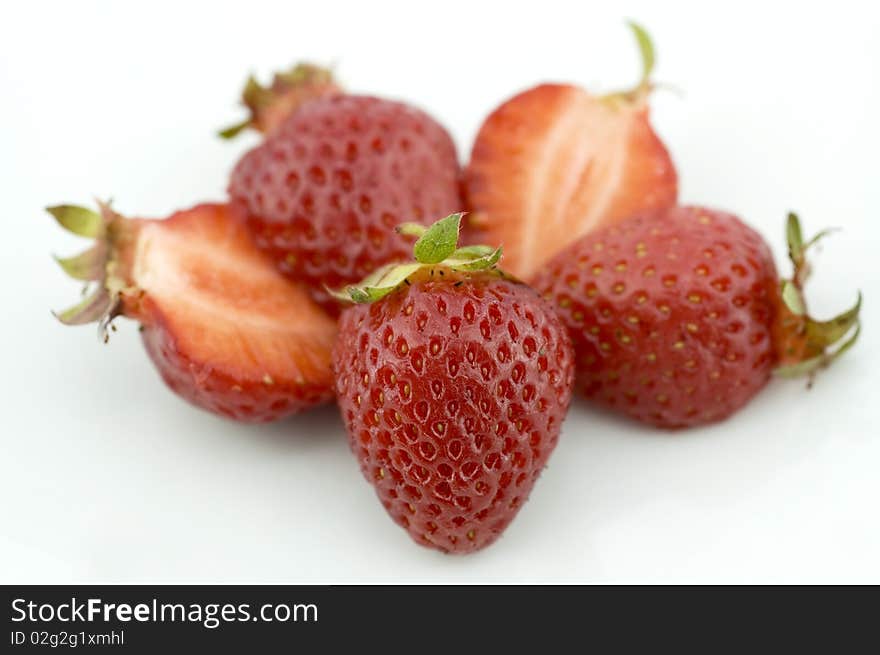 Fresh juicy Strawberries isolated on white. One cup (144 g) of strawberries constitutes approximately 45 calories (188 kJ) and is an excellent source of vitamin C and flavonoids.