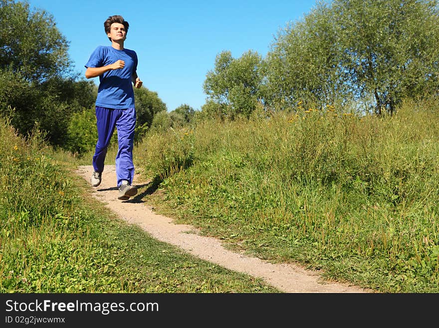 One man wearing sporty clothes is running