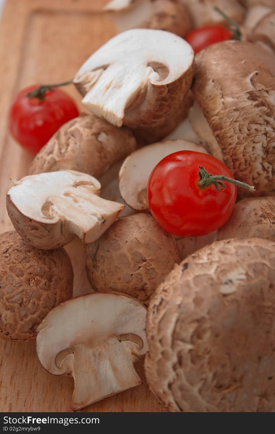 Fresh button mushroom, or champignon with cherry tomato