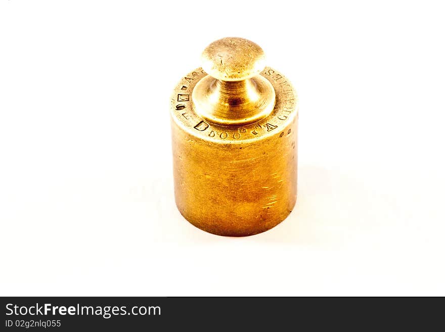 An antique iron weight on white background, useful for conceptual