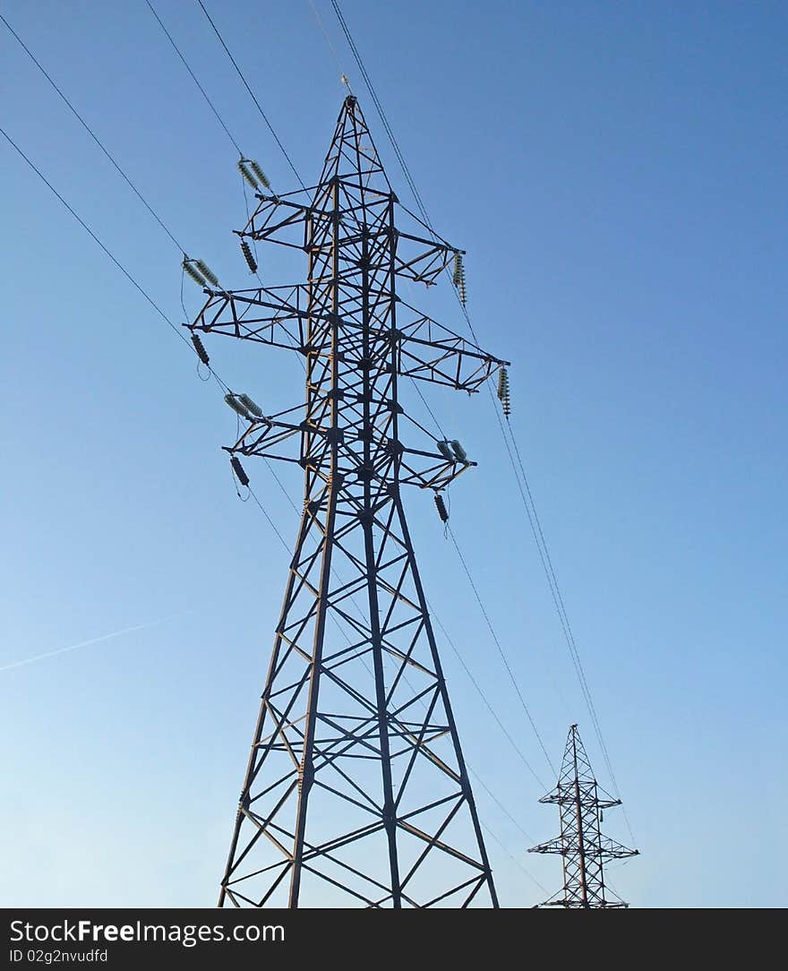 Support of a line of a high voltage, the blue sky with clouds. Support of a line of a high voltage, the blue sky with clouds